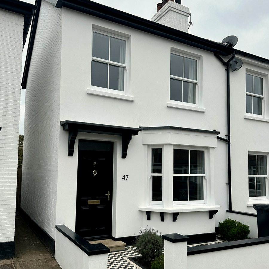 British terrace with freshly painted white walls, black door and painted window frames